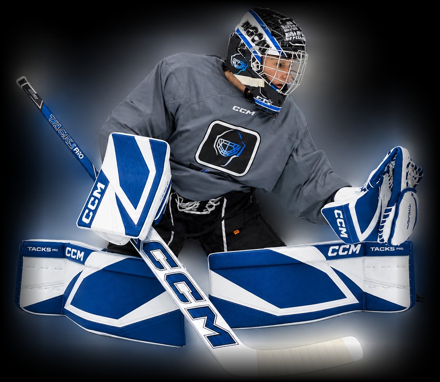 A young goaltender in FTC gear dropping into a butterfly save